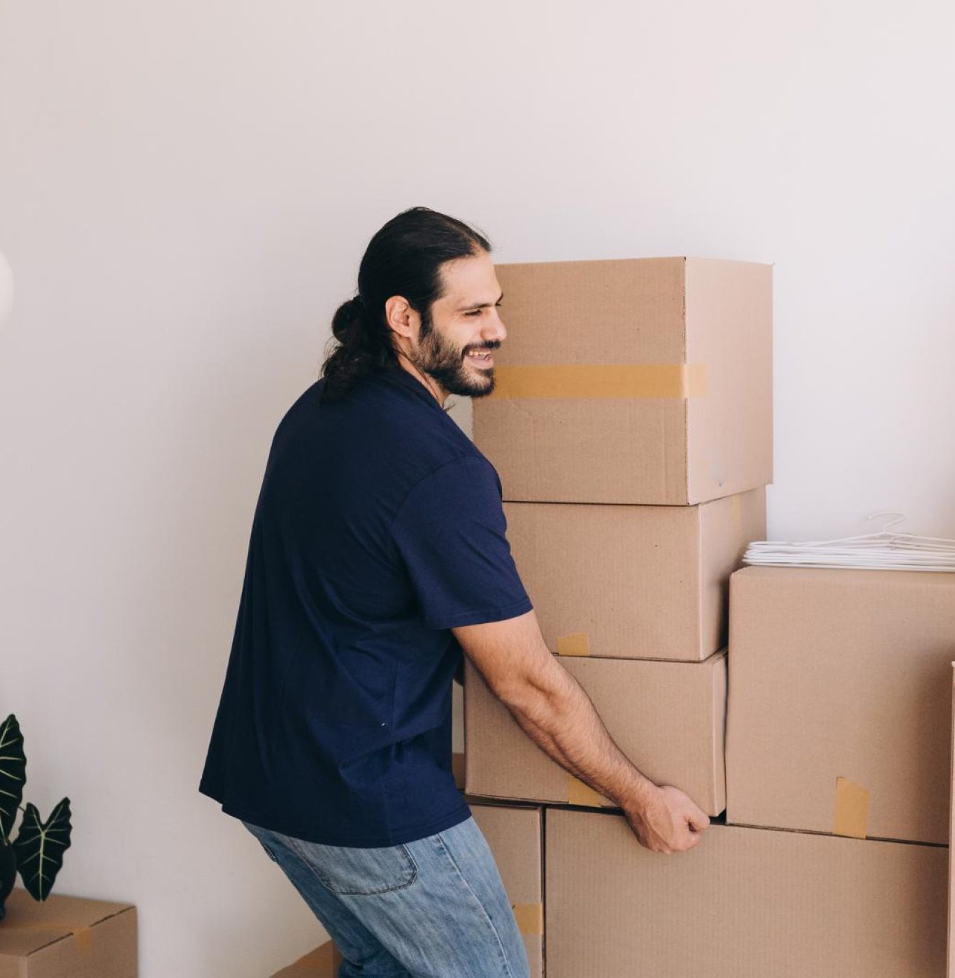 Professional movers near me in Dickinson, TX packing boxes and household items carefully