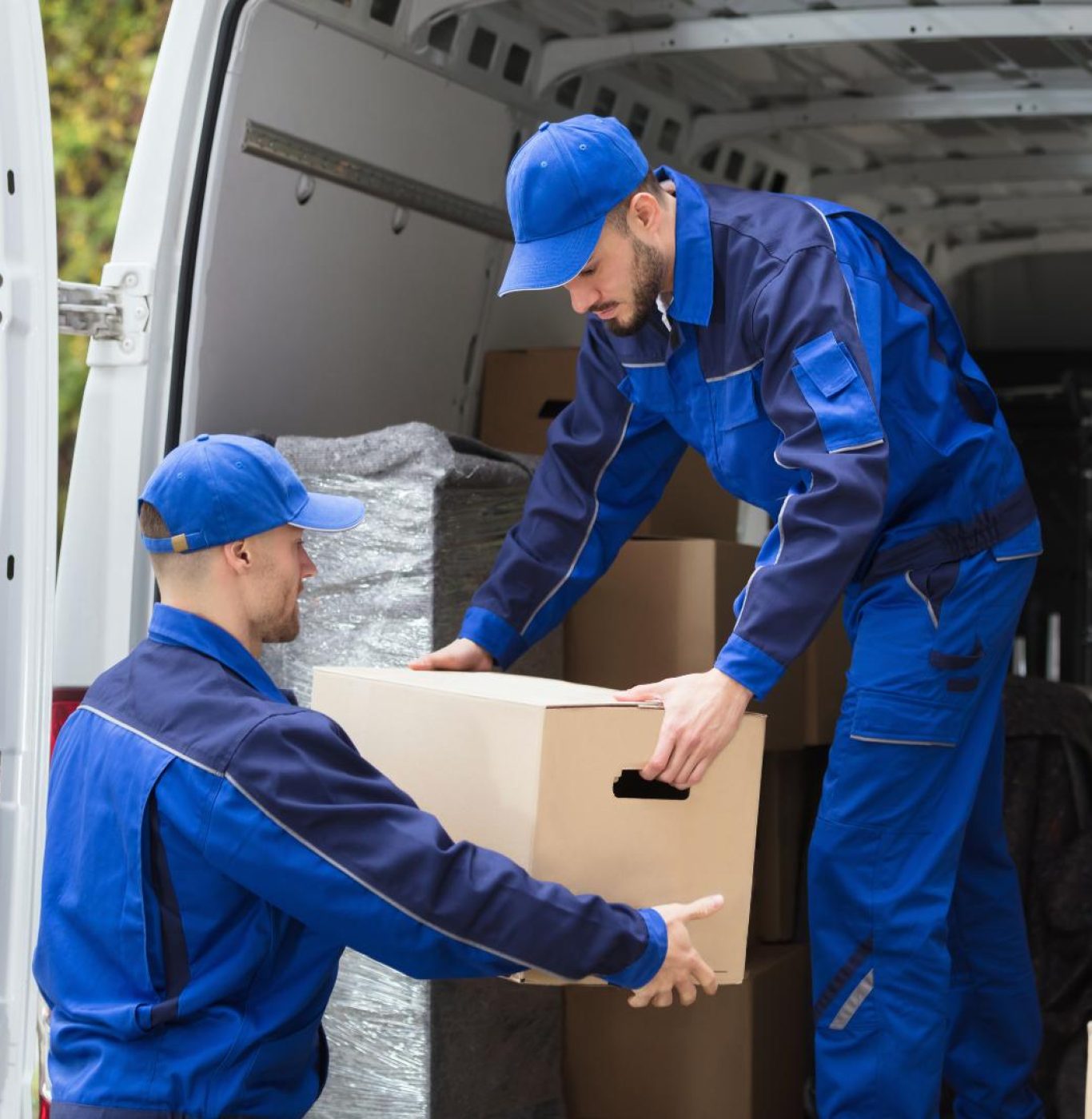 Reliable local movers in Pasadena, TX carrying furniture during a residential relocation
